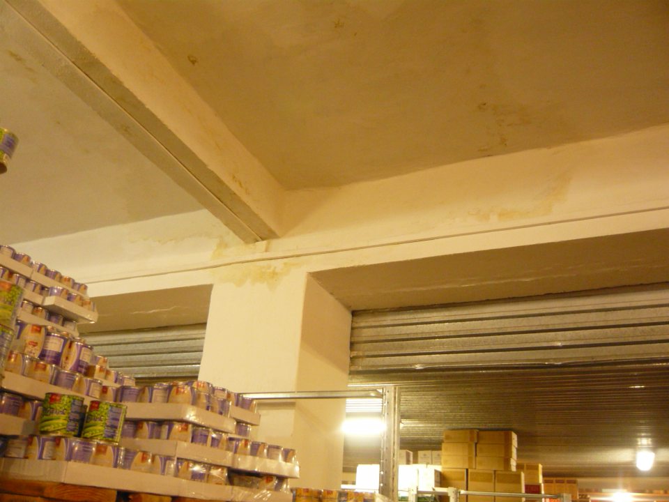 Zatečený strop a priľahlá stena v časti skladu so skladovanými alko a nealko nápojmi.