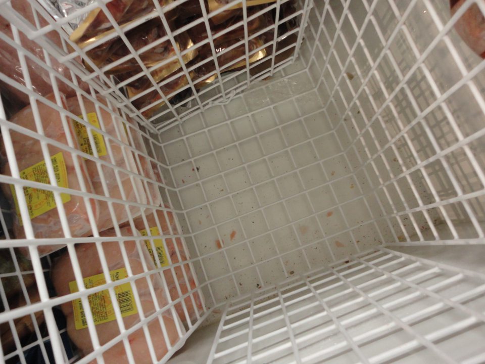 Na predajnej ploche dno mraziaceho zariadenia znečistené nečistotami a drobnými zvyškami potravín.