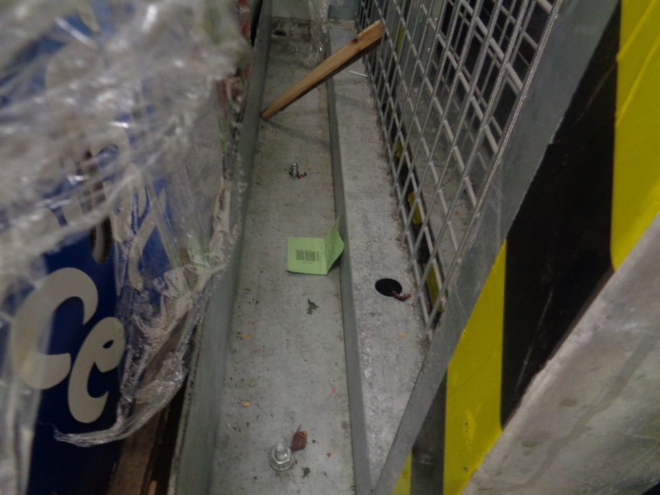 Podlaha v manipulačnom priestore prevádzkarne znečistená prachom, nánosmi zastaranej špiny a zvyškami obalového materiálu. 