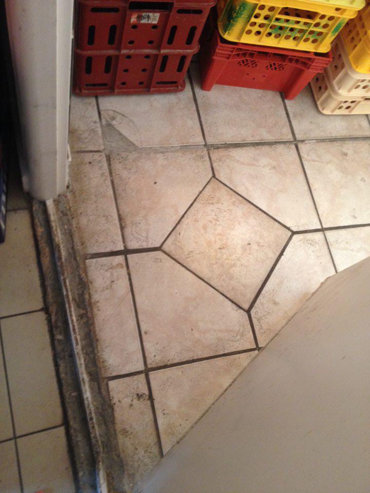 Poškodený prah dverí na príjme pekárenských výrobkov, znečistená podlaha.