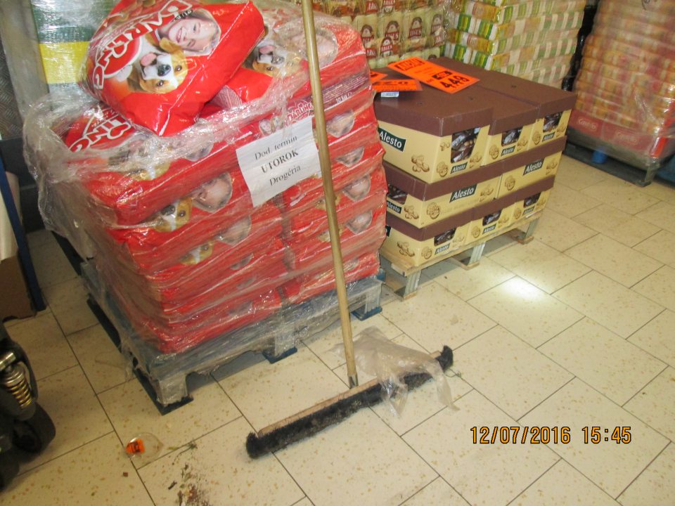 V zázemí prevádzky metla a nahrnuté nečistoty v blízkosti uskladnených potravín.