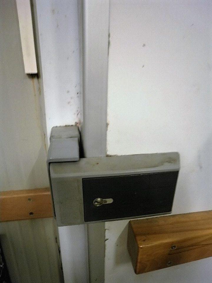 Znečistené dvere a lišty na zárubni na mraziacom boxe v skladových priestoroch prevádzky.