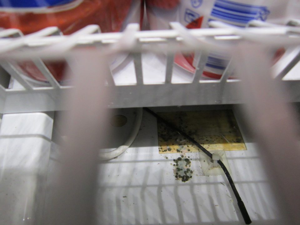 Znečistená chladiaca vitrína na mliečne výrobky.