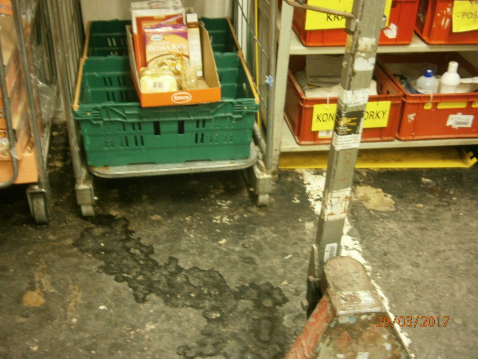 V prevádzke znečistená podlaha v sklade s odpisovým tovarom.
