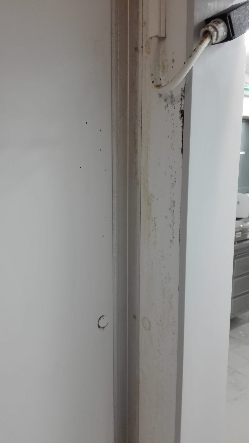 Znečistená zárubňa a stena chladiaceho boxu lahôdok.