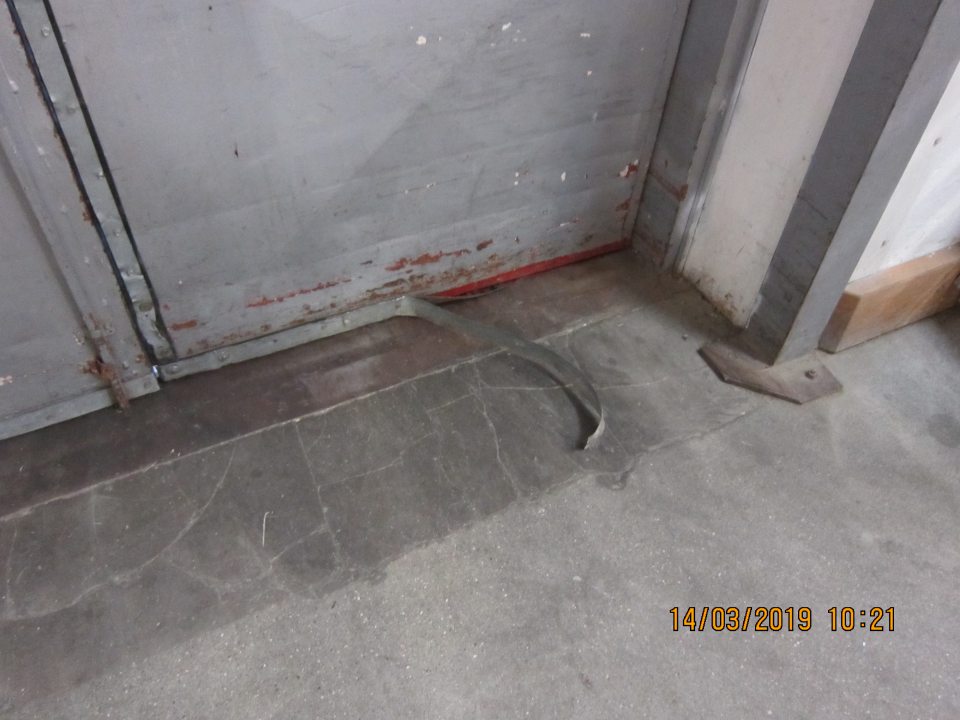 Poškodený plech na dverách na rampu.