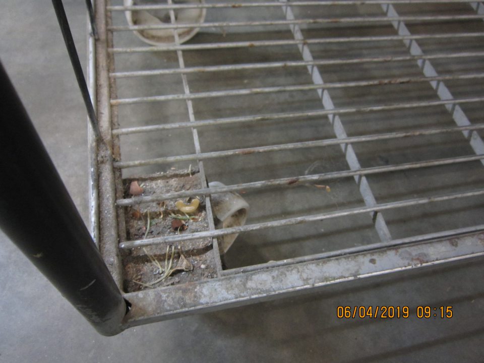 V zázemí prevádzky manipulačný vozík na potraviny znečistený nánosom prachu, nečistotami.