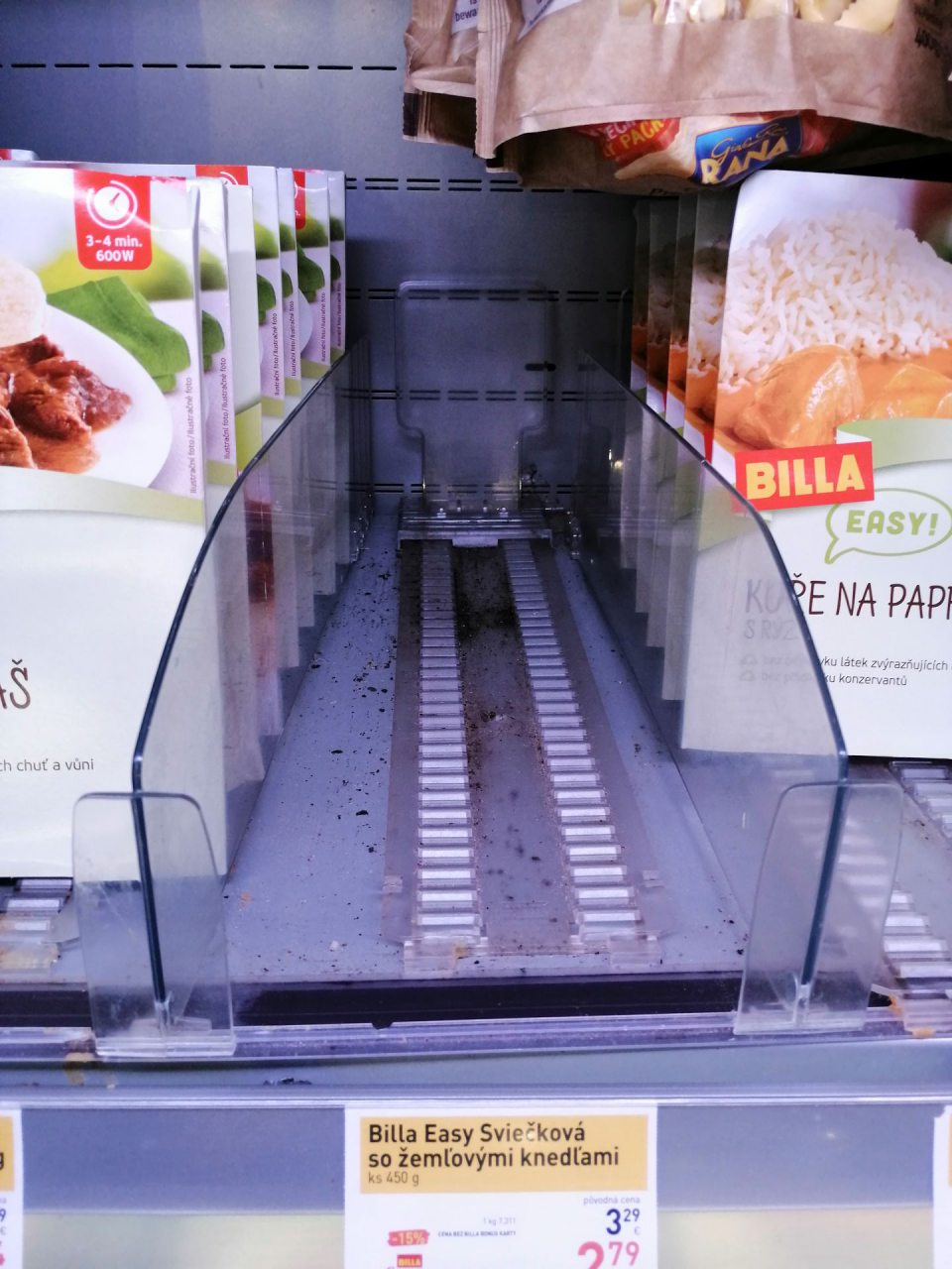 Znečistené plastové stojany v chladiacich vitrínach na predajnej ploche. 