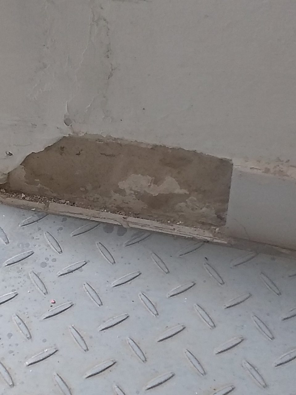 V chodbe pred vstupom do vonkajšieho priestoru poškodené a chýbajúce sokle.