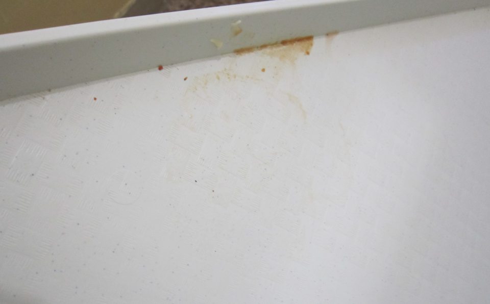 1. Znečistená ložná plocha chladiaceho zariadenia na mliečne výrobky v predajni. 