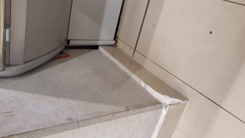 V spodnej časti stĺpu pred chladiarenskou vitrínou odbitá časť rohu.