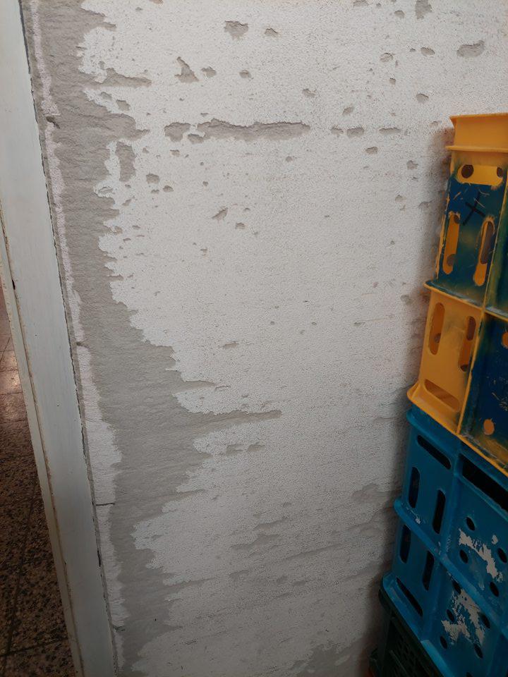 V skladových priestoroch v časti pre príjem pekárskych výrobkov poškodená stena pri paletách.