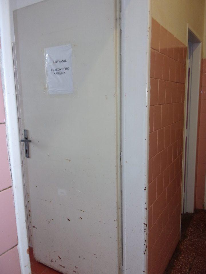 Poškodený hygienicky náter dverí do umyvárne pracovného náradia.