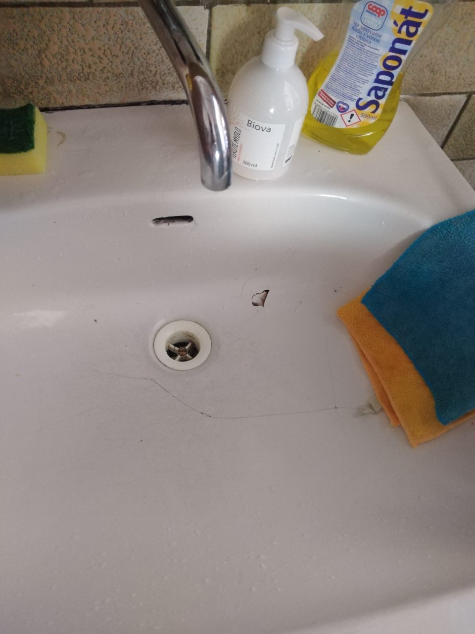 Poškodená podlaha a steny v priestoroch príjmu tovaru. - Poškodené a tečúce umývadlo v sklade. 