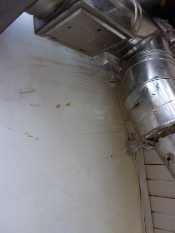 Poškodený a olupujúci sa hygienický náter steny nad pecou vo výrobnej časti prevádzky.