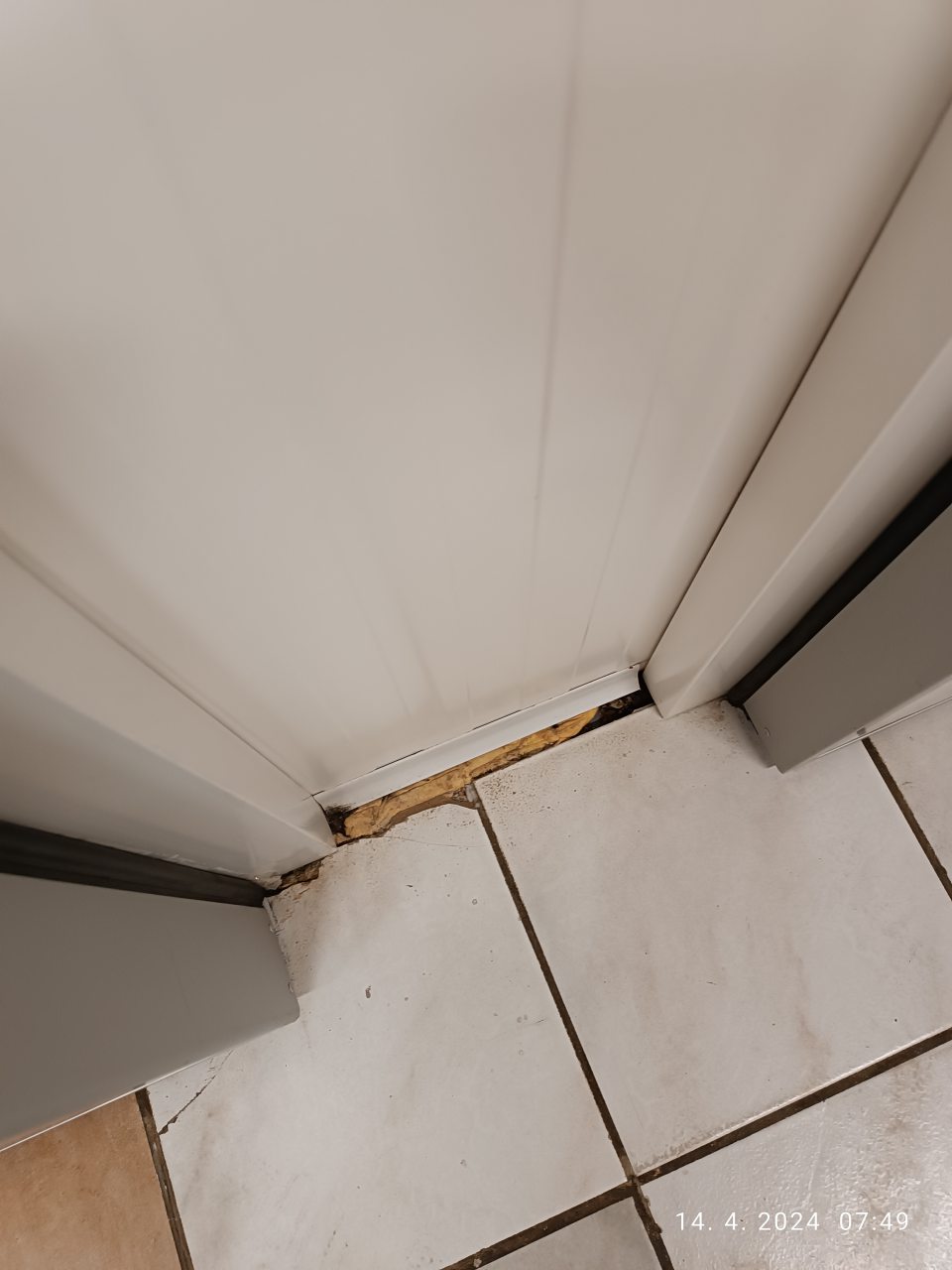 Špára čiastočne vyplnená pur penou v okolí chladiaceho boxu v zázemí predajne.