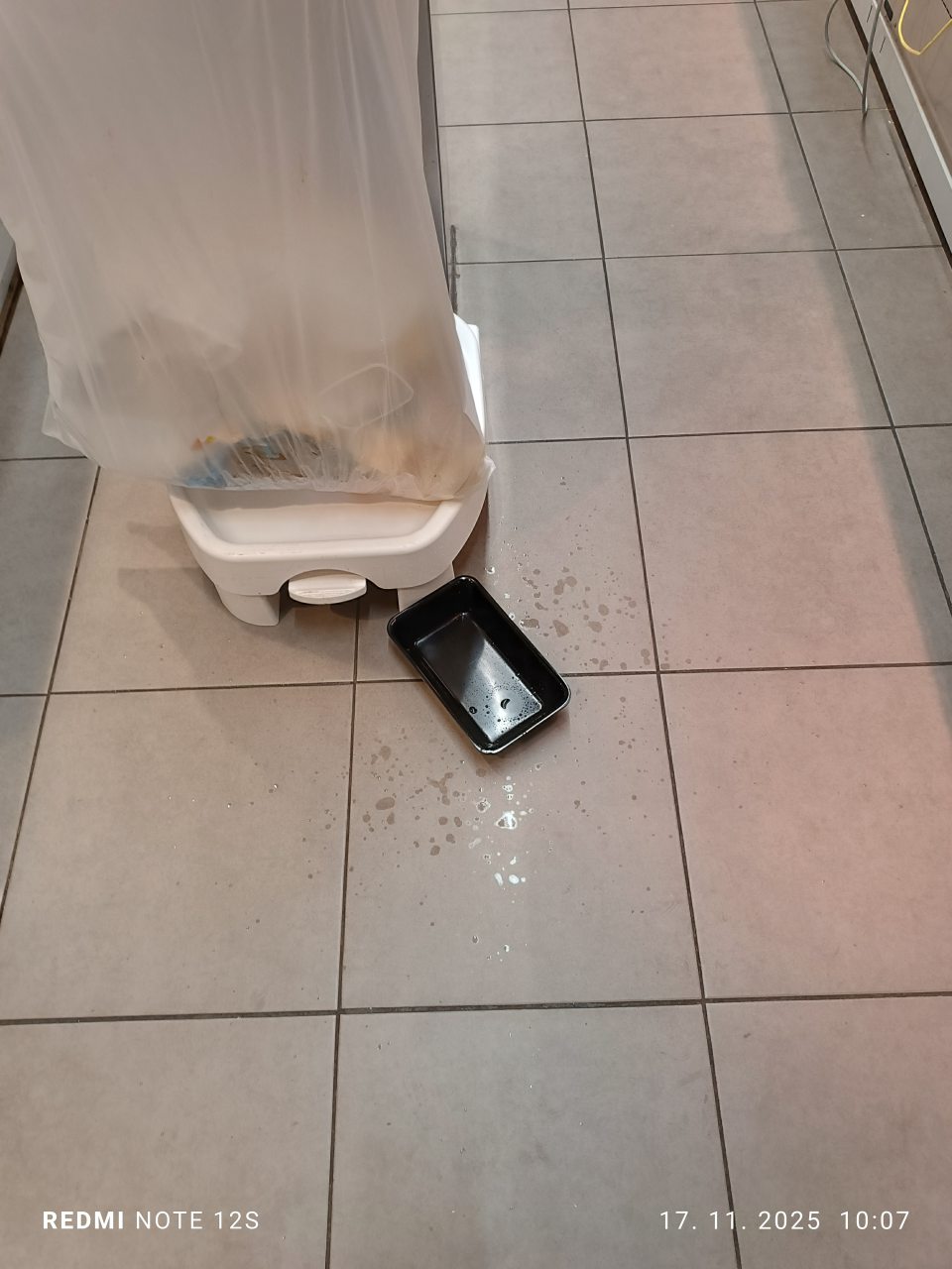 Voda kvapkajúca cez komín na dlážku za chladiacou vitrínou s lahôdkarskými a mäsovými výrobkami v predajni.