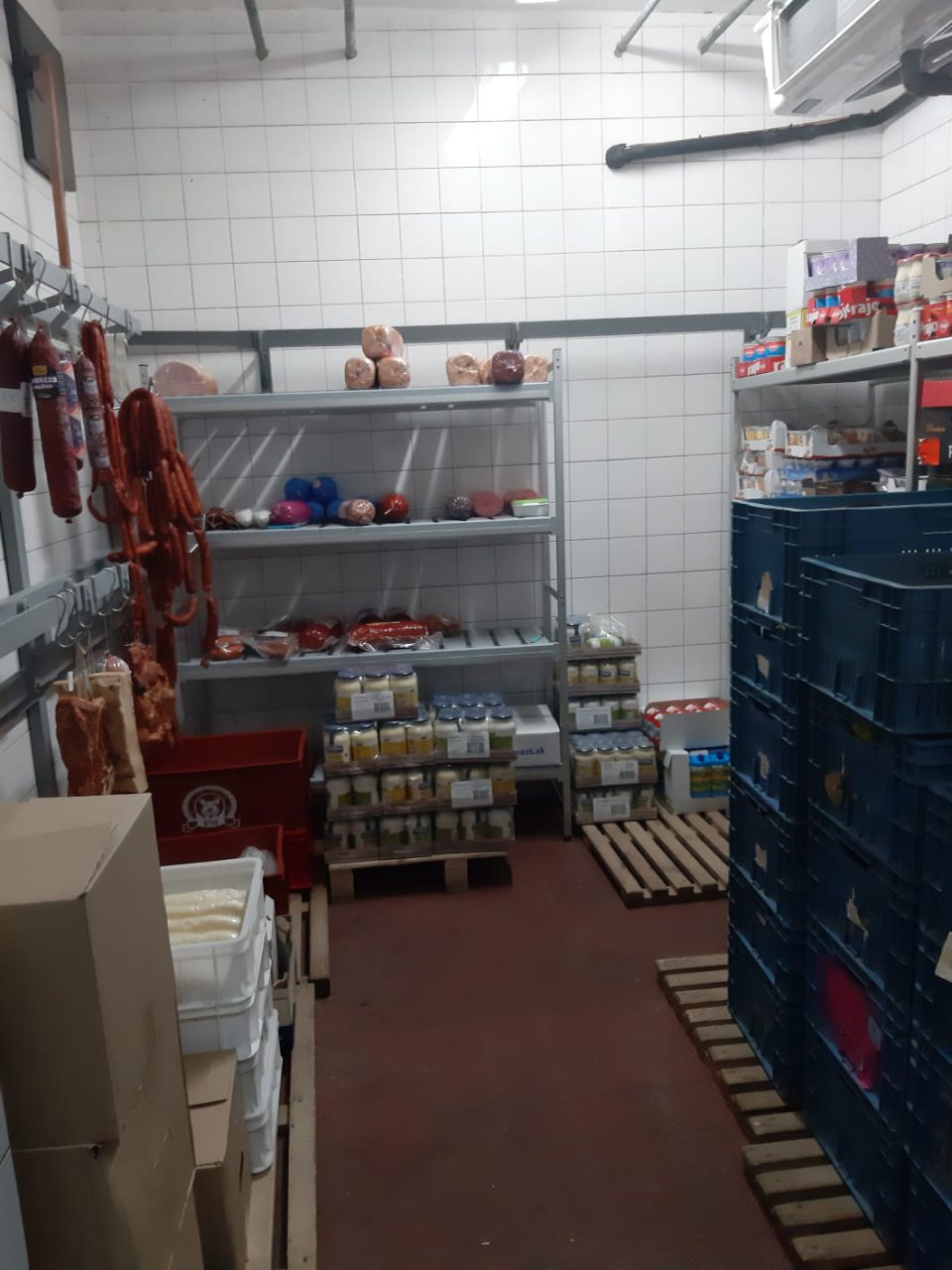 V chladiarenskom boxe v zázemí prevádzky sú spoločne skladované nebalené mäsové výrobky, ktoré visia na kovových hákoch a v umelohmotných prepravkách, ktoré sú znečistené hrubou vrstvou nečistoty je skladované ovocie a zelenina.