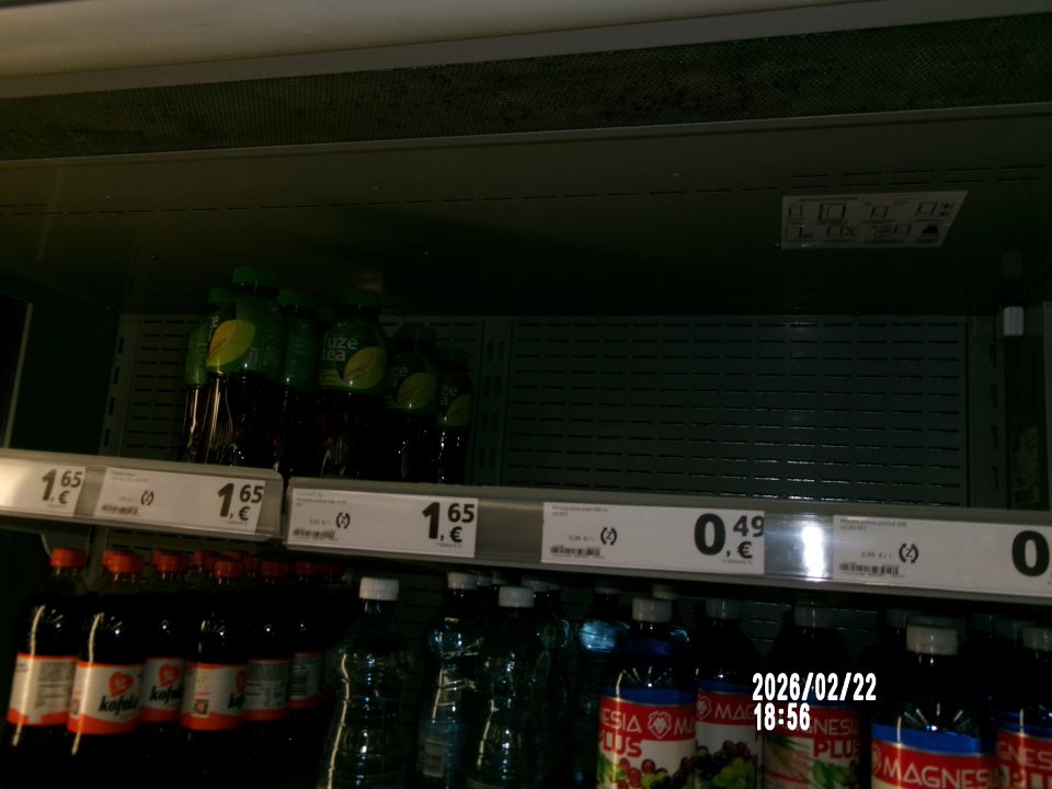  Znečistená vrchná kovová mriežka v chladiarenskom zariadení s uchovávanými nealko-nápojmi na predajnej ploche. 