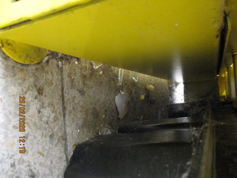 Na predajnej ploche na podlahe pod regálom s bonboniérami, cukrovinkami, konzervami a chipsami ponúkanými na predaj, zistený nános hrubej vrstvy prachu, potravinových zvyškov (ryža, slané tyčinky), zvyškov skla a pavučín v rozsahu cca 0,8 m x 1,5 m.